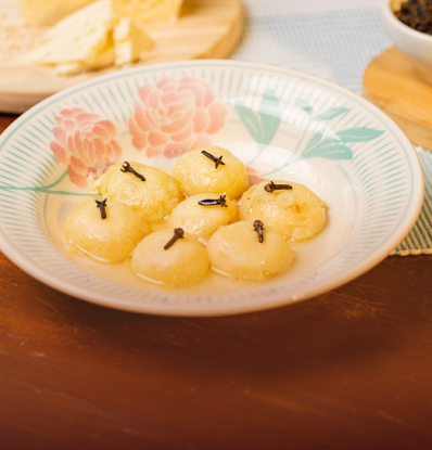 Prato floral com doces de queijo em formato de ameixa e cravos